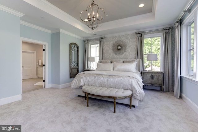 bedroom featuring ornamental molding, a tray ceiling, a chandelier, and light carpet