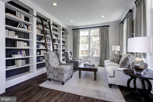 sitting room with crown molding and dark wood-type flooring