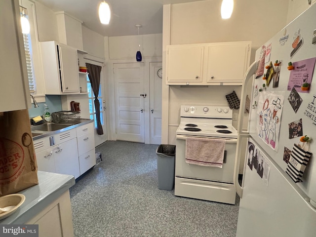 kitchen featuring white appliances and white cabinets