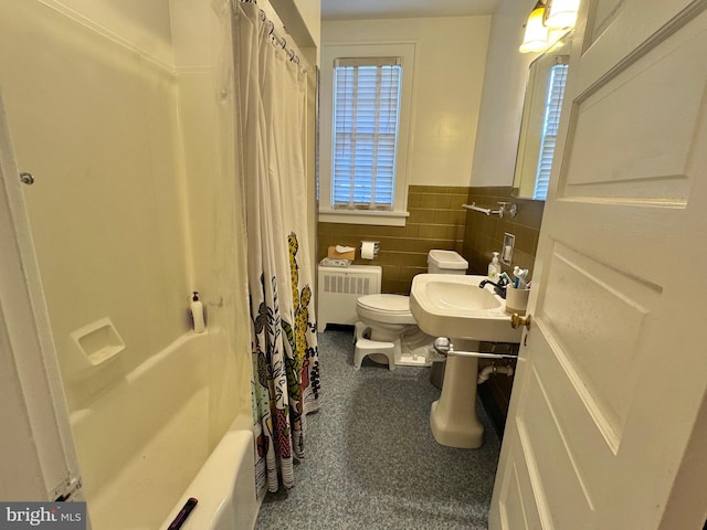 full bathroom featuring radiator, sink, tile walls, toilet, and shower / tub combo with curtain