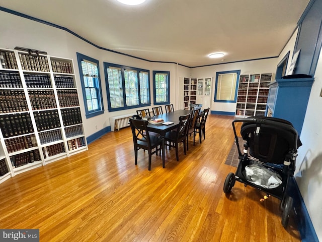 dining room with radiator heating unit and hardwood / wood-style flooring