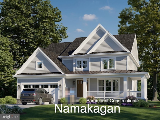 view of front of property with a porch, a garage, and a front yard