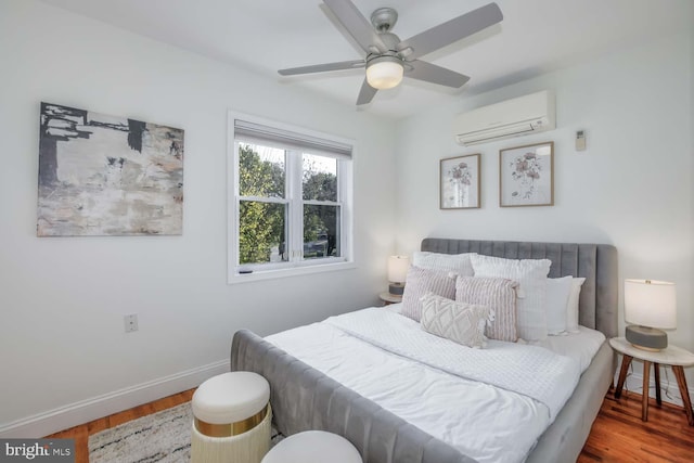 bedroom featuring ceiling fan, wood-type flooring, and a wall mounted AC