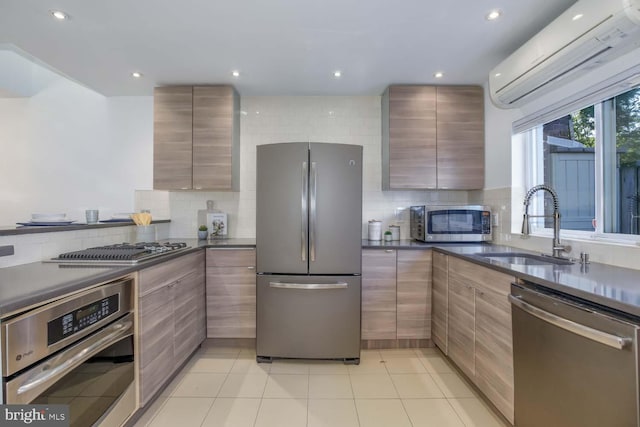 kitchen featuring sink, a wall mounted air conditioner, backsplash, light tile patterned flooring, and appliances with stainless steel finishes