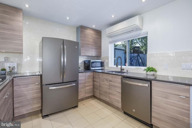 kitchen with sink, a wall unit AC, backsplash, light tile patterned floors, and appliances with stainless steel finishes