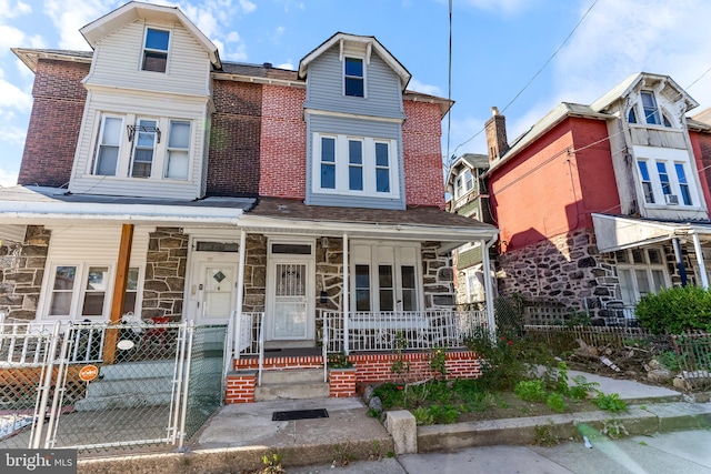 townhome / multi-family property with a porch