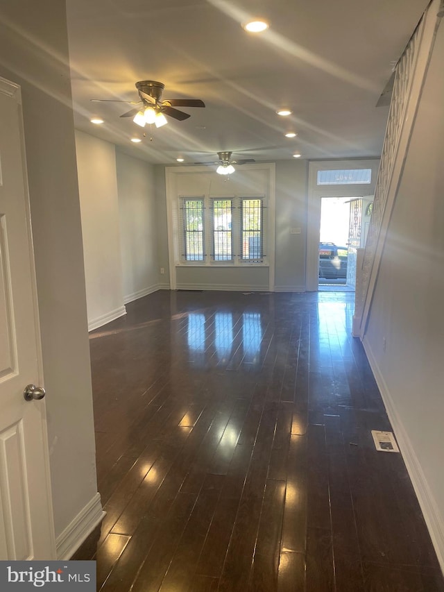 unfurnished room featuring dark wood-type flooring and ceiling fan