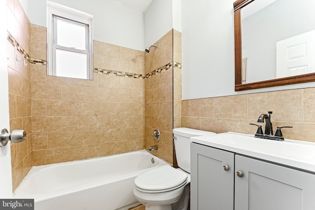 full bathroom with toilet, tasteful backsplash, tile walls, tiled shower / bath, and vanity