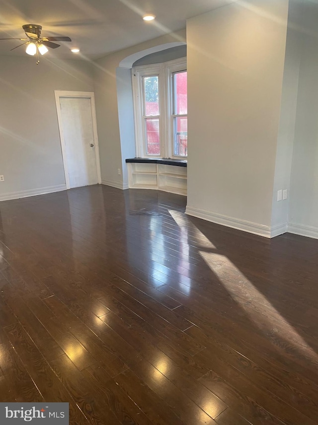 spare room featuring ceiling fan and dark hardwood / wood-style floors