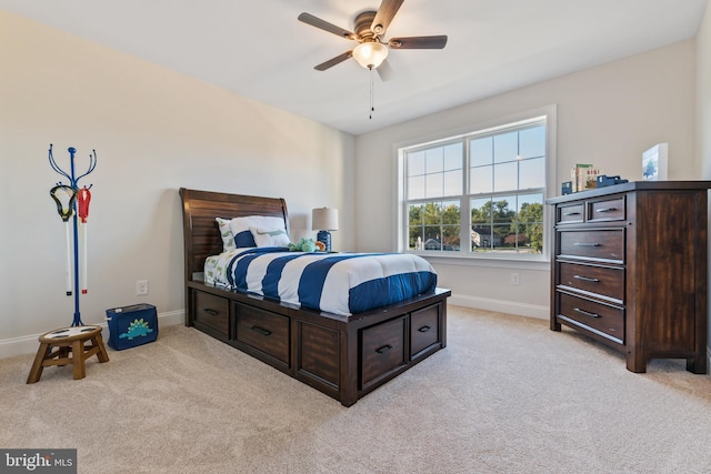 bedroom with a ceiling fan, light colored carpet, and baseboards