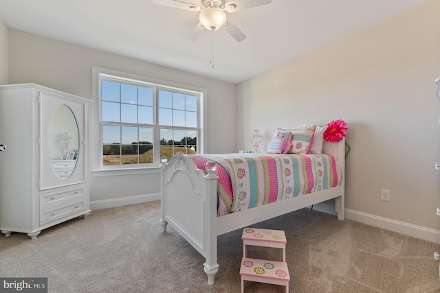 bedroom featuring baseboards, a ceiling fan, and light colored carpet