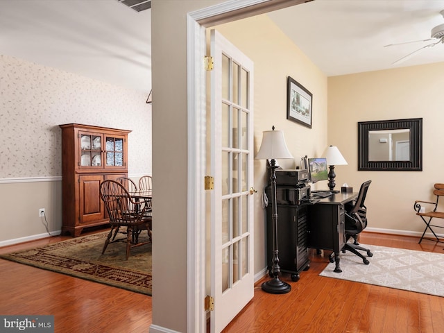 home office featuring french doors, hardwood / wood-style flooring, and ceiling fan