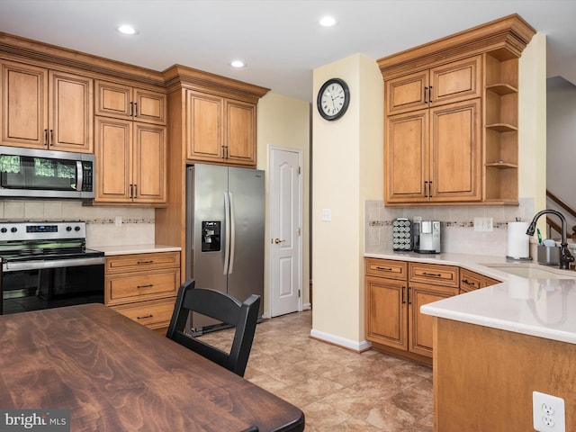 kitchen with stainless steel appliances, sink, tasteful backsplash, and wood counters