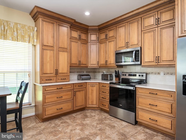 kitchen featuring appliances with stainless steel finishes and tasteful backsplash