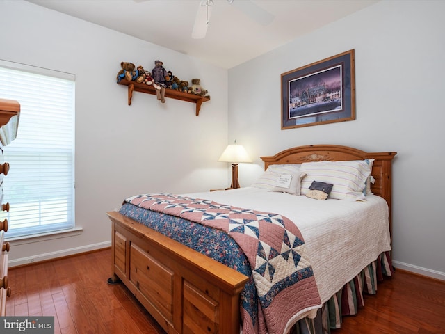 bedroom with ceiling fan and dark hardwood / wood-style flooring