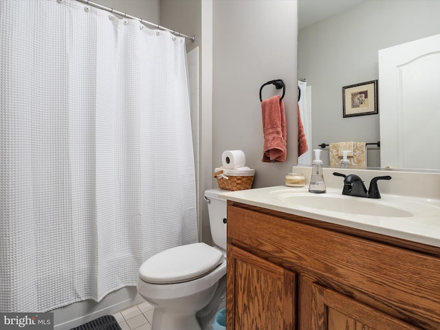 bathroom featuring a shower with shower curtain, vanity, toilet, and tile patterned floors