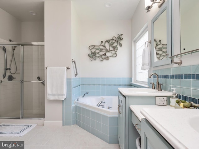 bathroom with tile patterned flooring, vanity, and shower with separate bathtub