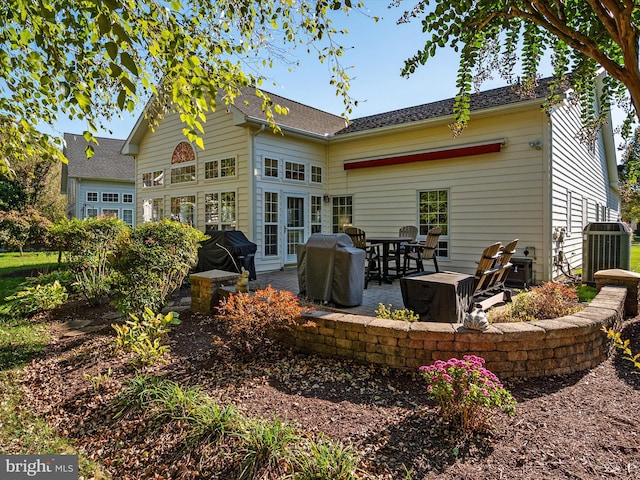 back of property featuring french doors and a patio area