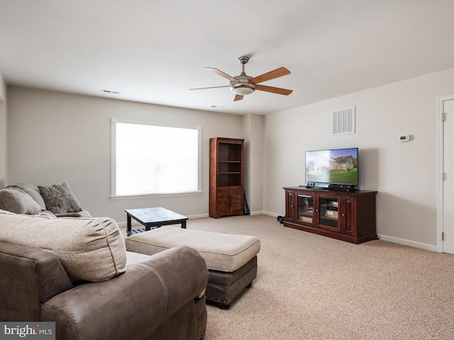 carpeted living room with ceiling fan