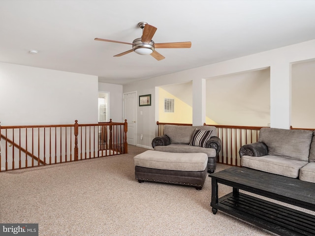 carpeted living room with ceiling fan