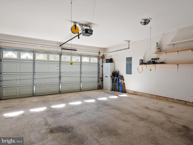 garage with a garage door opener and electric panel