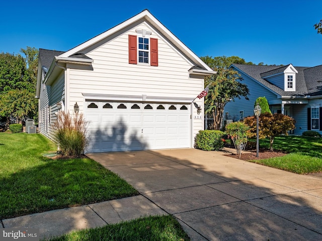 view of property with cooling unit, a front yard, and a garage