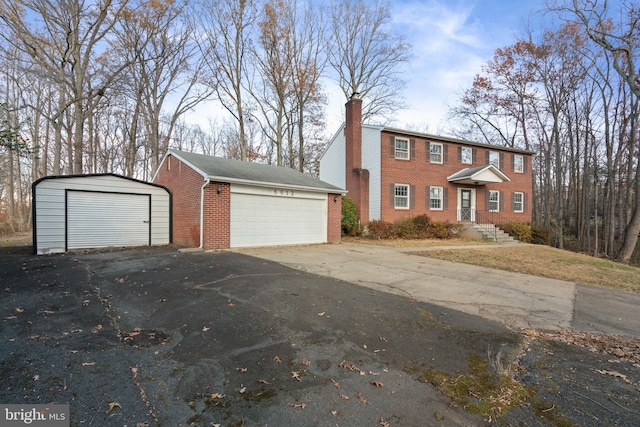 view of front of property featuring a garage and an outdoor structure