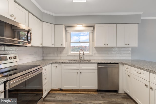 kitchen with sink, appliances with stainless steel finishes, white cabinets, and dark hardwood / wood-style flooring