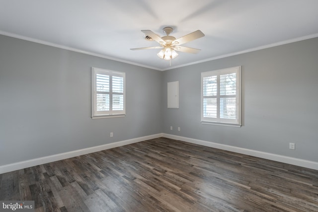 spare room featuring ornamental molding, a healthy amount of sunlight, and dark wood-type flooring