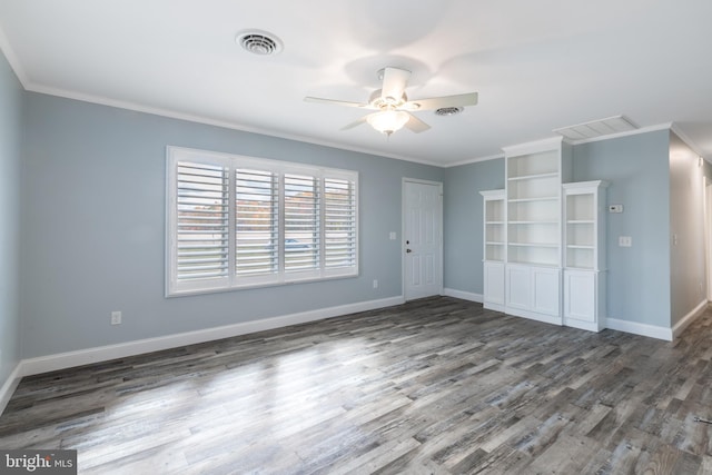 spare room featuring ornamental molding, dark wood-type flooring, and ceiling fan