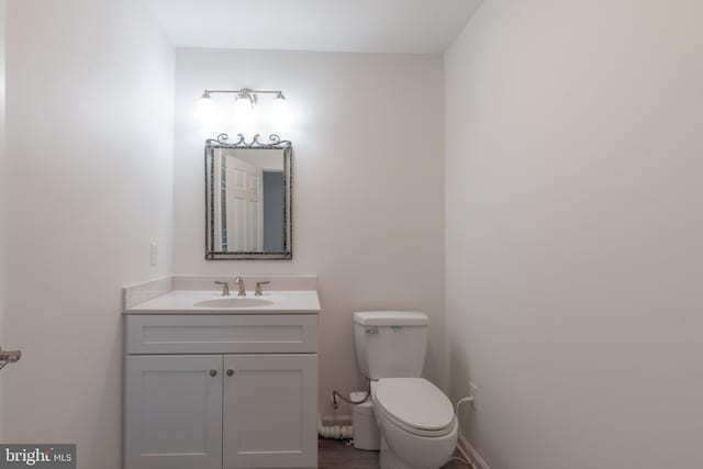 bathroom featuring toilet and vanity