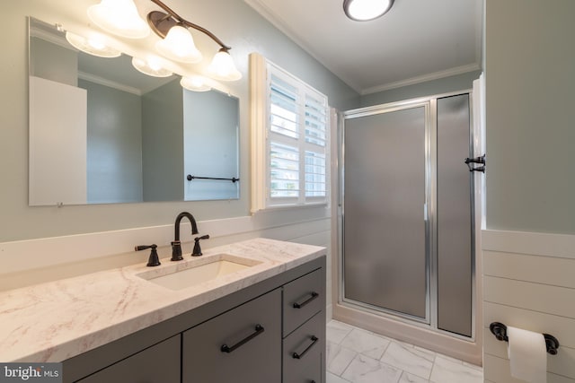 bathroom featuring a shower with door, vanity, and crown molding