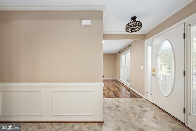 foyer featuring hardwood / wood-style flooring and ornamental molding