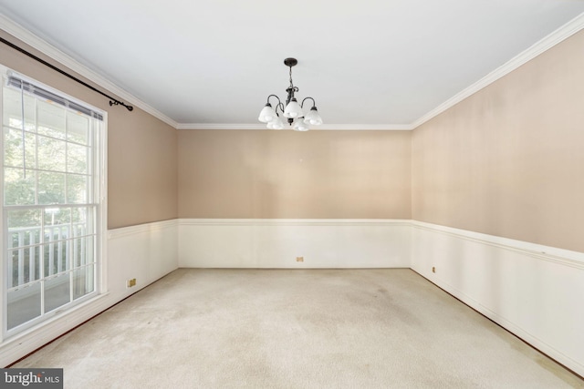 unfurnished room with ornamental molding, a chandelier, and carpet