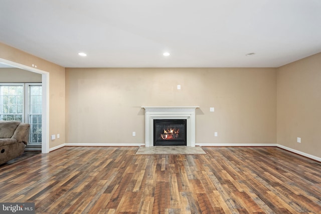 unfurnished living room featuring dark hardwood / wood-style floors