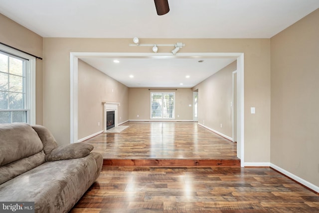 living room featuring hardwood / wood-style floors and ceiling fan