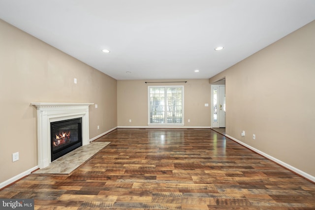 unfurnished living room featuring dark wood-type flooring