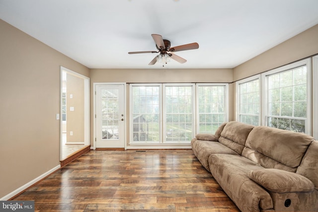 living room featuring dark hardwood / wood-style flooring, ceiling fan, and plenty of natural light