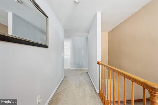 hall featuring light colored carpet