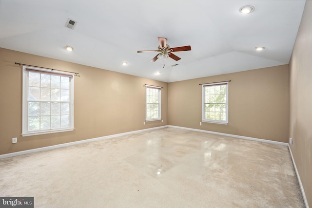 carpeted empty room featuring vaulted ceiling and ceiling fan