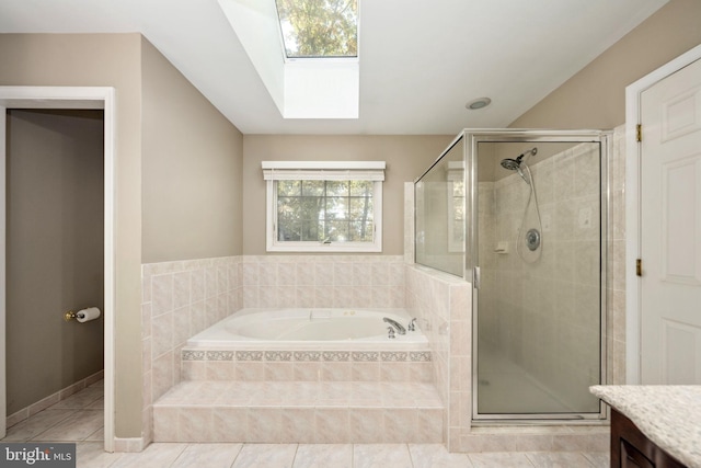 bathroom with vanity, separate shower and tub, tile patterned floors, and a skylight