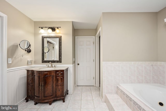 bathroom with vanity, tiled tub, and tile patterned flooring