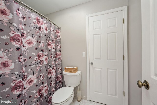 bathroom featuring toilet and tile patterned floors