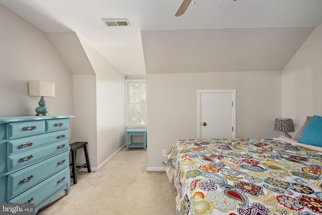 carpeted bedroom with ceiling fan and vaulted ceiling