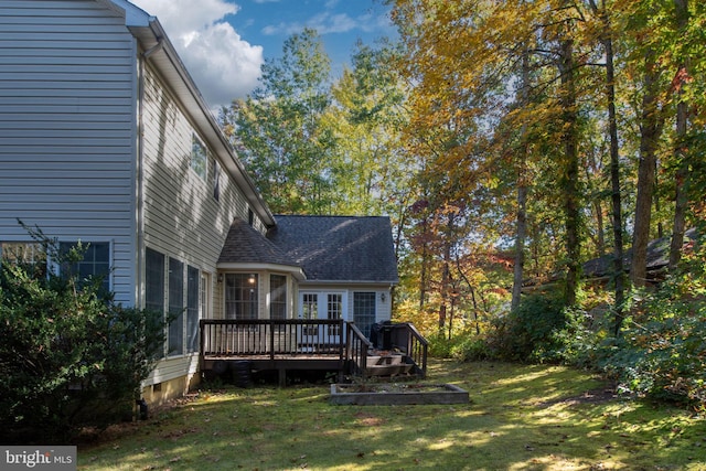 back of house featuring a deck and a lawn