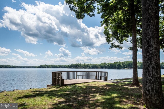 dock area featuring a yard and a water view