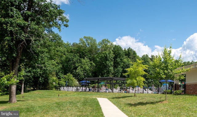 surrounding community with a yard and a pergola