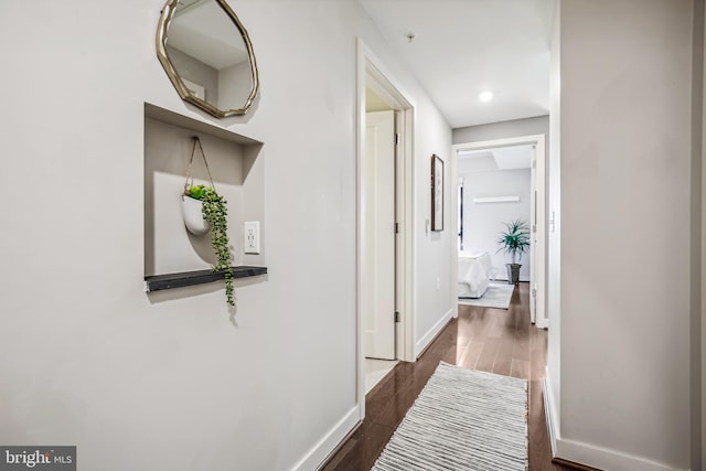 corridor featuring dark wood-type flooring