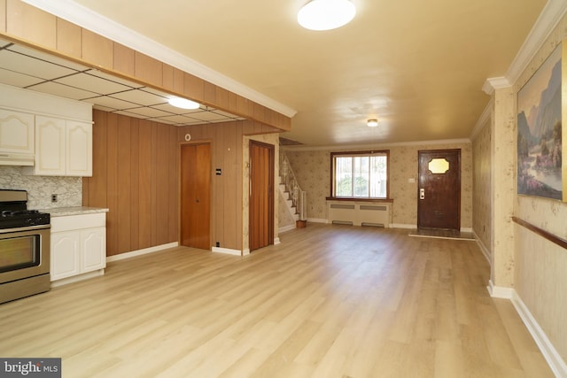 kitchen featuring white cabinetry, stainless steel range oven, light hardwood / wood-style floors, extractor fan, and ornamental molding