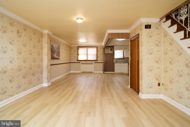 unfurnished room featuring radiator heating unit, hardwood / wood-style flooring, and crown molding